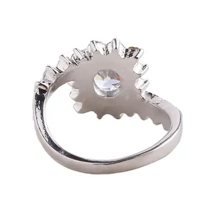 Detailed side view of silver ring with sunflower setting and round clear gemstone
