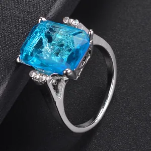 Sparkling silver ring with a rectangular blue crystal stone and pavé diamond accents