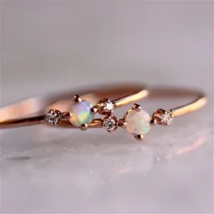 Elegant rose gold minimalist rings with opal center stones and side zircon accents