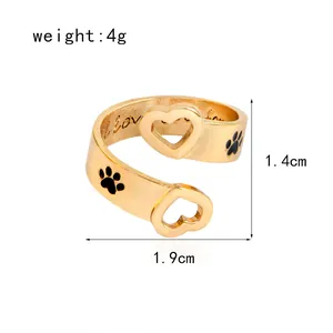 Golden open ring with heart ends, black paw prints, and I love you engraving