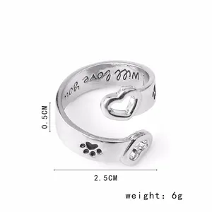 Detailed macro view of heart and paw ring band showing interior will love you engraving