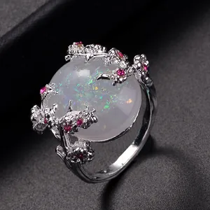 Silver flower branch ring with oval opal gemstone and pink crystal accents