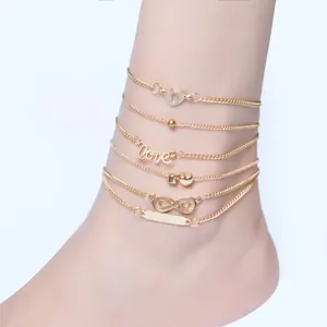 Detailed view of 6-piece gold anklet set featuring love heart and infinity charms