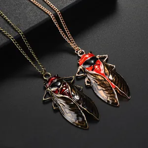 Macro shot of retro cicada pendants with detailed enamel wings on a black texture