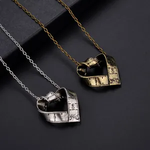 Retro heart-shaped measuring tape necklaces in silver and antique gold finishes