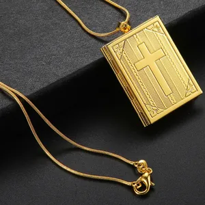 Golden book-shaped locket necklace with engraved cross design and snake chain