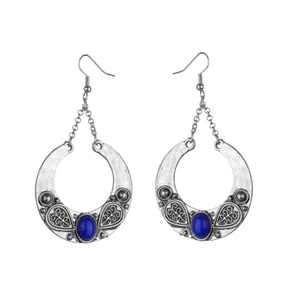 Detailed view of bohemian antique silver drop earrings with blue gemstones and heart pattern