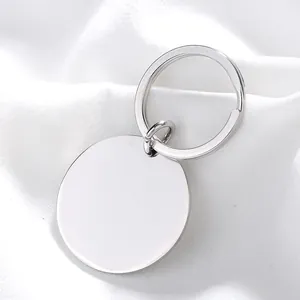 Detailed view of a polished stainless steel round keychain with blank metal pendant tag