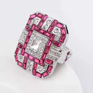 Close-up of Art Deco cocktail ring with ruby red stones and rectangular crystal setting