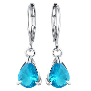Close-up of blue pear-cut crystal drop earrings with silver lever-back clasps