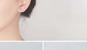 Primer plano de un pendiente minimalista de plata con forma de gato puesto en la oreja