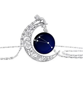Macro shot of silver crescent moon necklace featuring Taurus zodiac constellation detail
