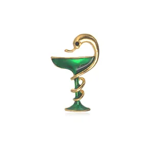 Golden bowl of Hygieia medical brooch with green enamel snake for pharmacists