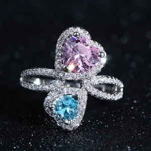 Macro detail of intertwined heart-shaped crystals in pink and blue with pave zircons