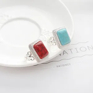 Detailed macro view of vintage silver rings with red and turquoise gemstone inlay