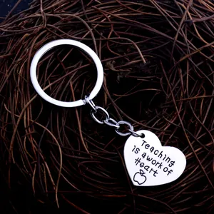 Silver stainless steel heart keychain with Teaching is a work of heart engraving