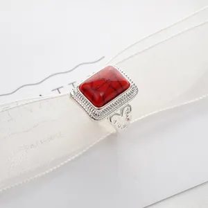 Vintage silver-plated ring featuring a large rectangular red stone with ethnic hollow pattern