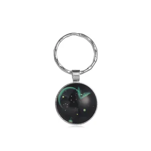Detalle de llavero del zodiaco galaxia con cúpula de vidrio verde estilo aurora boreal