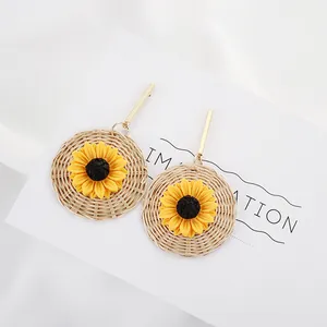 Bohemian style hand-woven rattan drop earrings with yellow sunflower design and gold metal stem