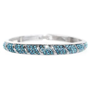 Detail of silver bangle with pavé-set sky blue rhinestones and elegant diagonal pattern