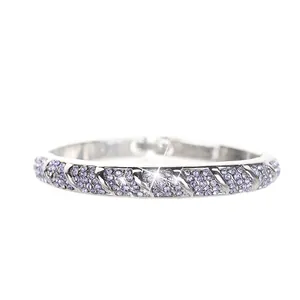 Detailed view of silver-tone bangle with pavé-set purple crystals and textured diagonal pattern