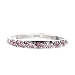 Detail of pink crystal pavé rhinestones on a woven silver fashion bracelet band