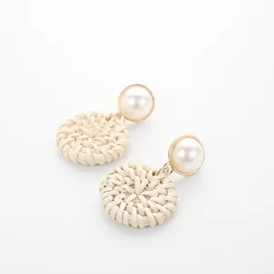 Fashionable woven rattan disc earrings with large white imitation pearl stud detail