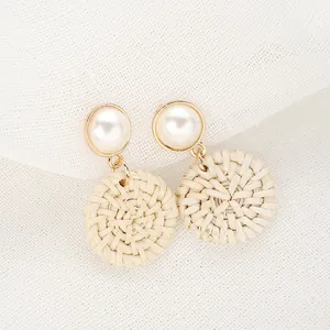Bohemian woven straw drop earrings with round white pearl studs and gold metal trim