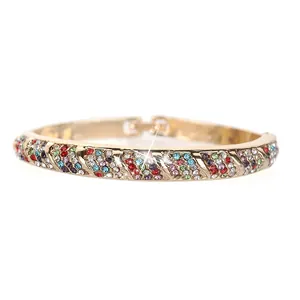 Golden alloy bangle featuring colorful rhinestones and diagonal striped design