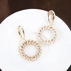 Bohemian woven drop earrings with golden shell stud and round rattan pendant