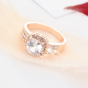 Detailed close-up of rose gold halo engagement ring with brilliant round zircon stone