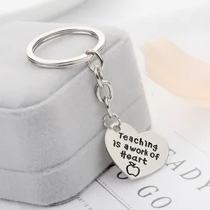 Detailed view of silver heart keychain with Teaching is a work of Heart engraving