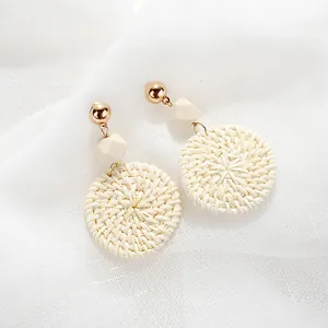Bohemian woven drop earrings with gold studs, wooden beads and beige rattan hoops