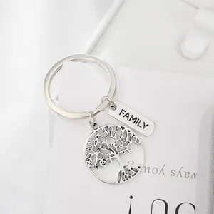 Close-up of silver family tree of life keychain with engraved family metal tag