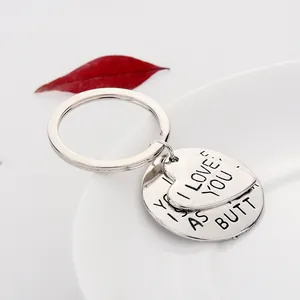 Vintage silver heart and round tag keychain with I LOVE YOU engraving on white plate
