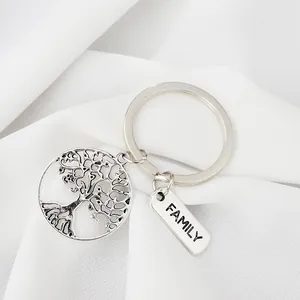 Macro view of silver family tree keychain with hollow tree and family engraving