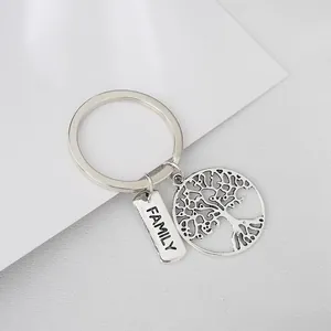 Vintage silver family tree keychain with engraved family tag on grey background