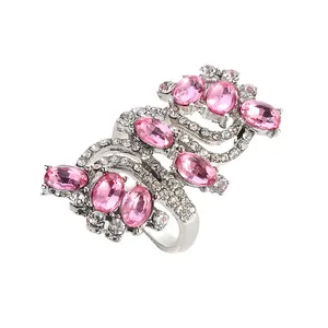 Detailed view of silver S-shape ring featuring pink crystals and white pave zircons