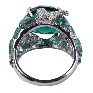 Vintage silver ring featuring a large green oval gemstone and marquise crystal accents