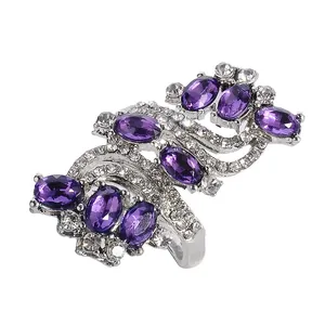Macro detail of silver S-shaped ring featuring purple oval crystals and pavé diamonds