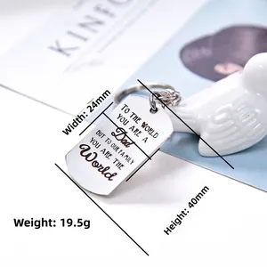 Close-up of rectangular polished steel DAD keychain showing emotional laser engraving