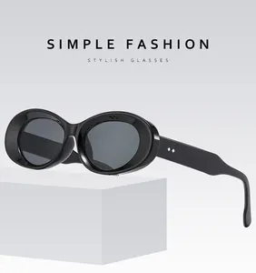 Detail of black oval sunglasses featuring wide temples and silver diamond rivets