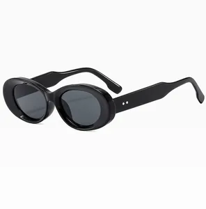 Detail view of oval retro sunglasses with thick black frames and silver diamond rivets