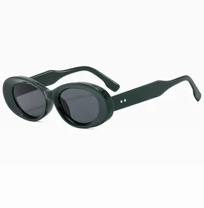 Detail view of oval sunglasses with forest green frame and silver diamond rivets