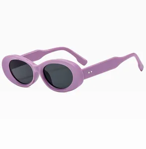 Detail view of oval purple frame sunglasses with black lenses and silver rivet accents