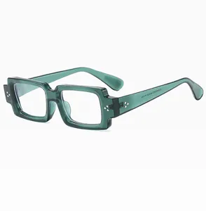 Close-up of dark green thick-frame square sunglasses with decorative metal rivets