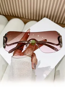 Detail view of oversized rimless Y2K sunglasses with brown to pink gradient lens