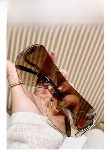 Detail view of brown gradient rimless sunglasses with silver metal temple accents