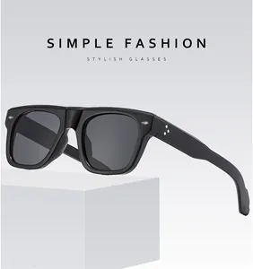 Close-up of square polarized sunglasses with three silver star rivets on the black temple
