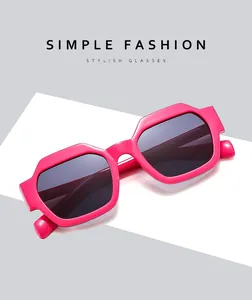 Detailed view of glossy pink geometric sunglasses with dark lenses and durable thick frame